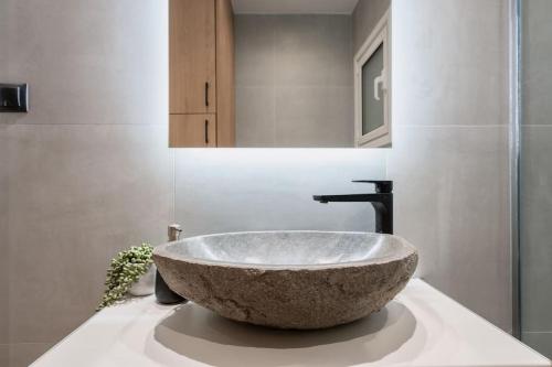 La salle de bains est pourvue d'un grand évier en pierre sur un comptoir. dans l'établissement The Heart Of Athens, à Athènes
