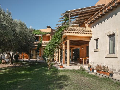 a house with a yard in front of a building at Masseria Scannaturco in Marina di Pisticci