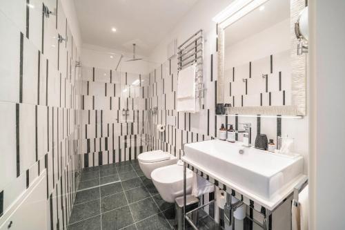 a white bathroom with a sink and a toilet at Villa Steiner 5 - Suzuka in Merano