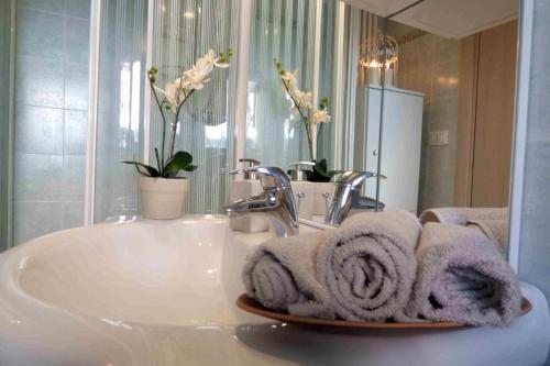 a bathroom with a sink with towels on it at Residence Valeria in Cervia