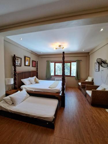 a bedroom with two beds and a couch at Amansara Private Resort in Pansol