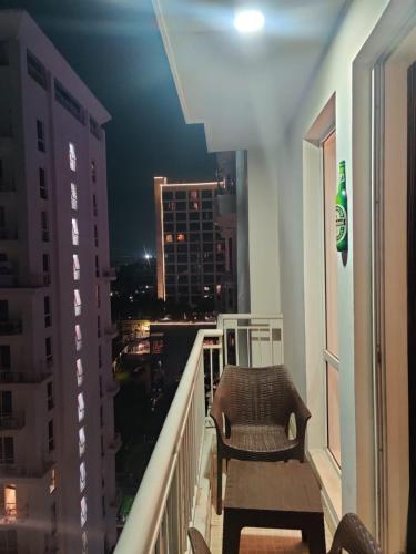 a balcony with a chair and a view of a city at The Nest Lucknow in Lucknow