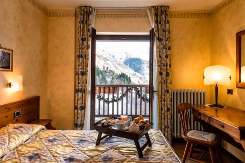 Postel nebo postele na pokoji v ubytování Hotel Beau Site