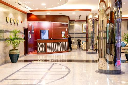 a lobby with a waiting area in a building at Wescott Pearl Hotel Apartments in Dubai