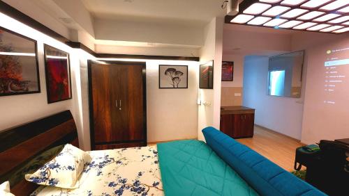 a living room with a blue couch in a room at The Nest Lucknow in Lucknow