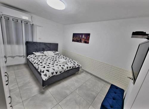a bedroom with a bed with a black and white comforter at אחוזת רזים - Villa Razim in Safed
