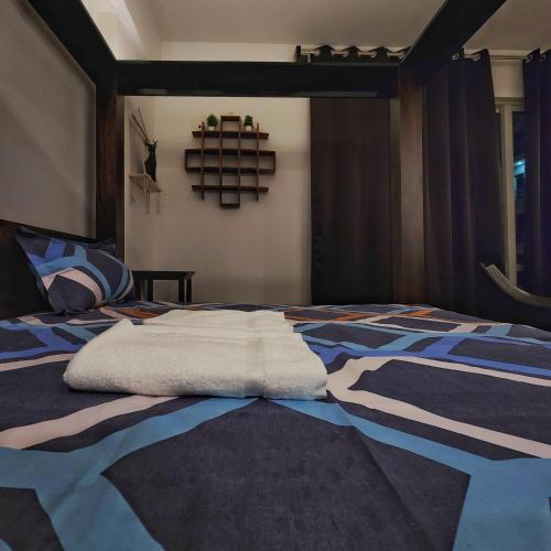 a bed with a white pillow on top of it at The Nest Lucknow in Lucknow