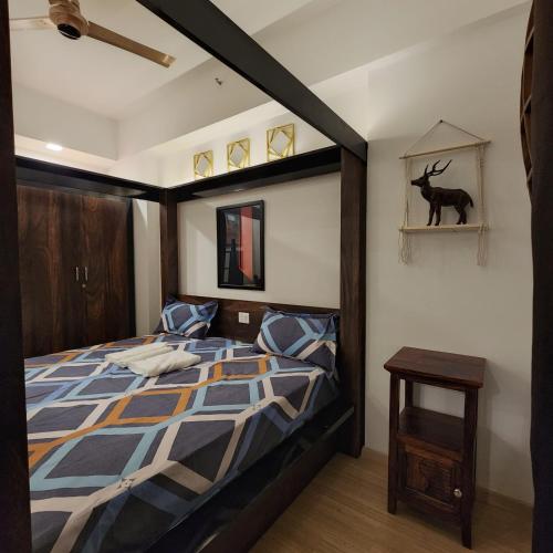a bedroom with a large bed with a wooden frame at The Nest Lucknow in Lucknow