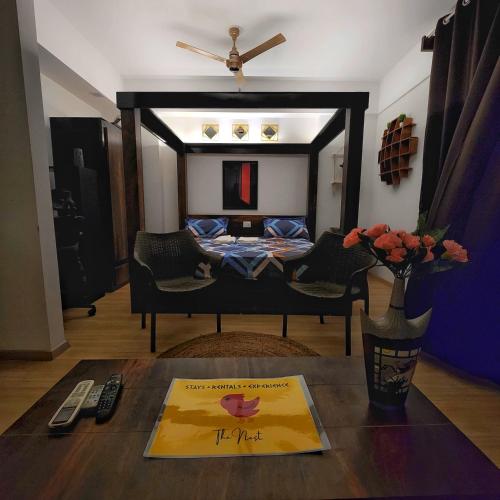 a living room with a bed and a table at The Nest Lucknow in Lucknow