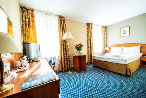 Postel nebo postele na pokoji v ubytování Warmiński Hotel & Conference