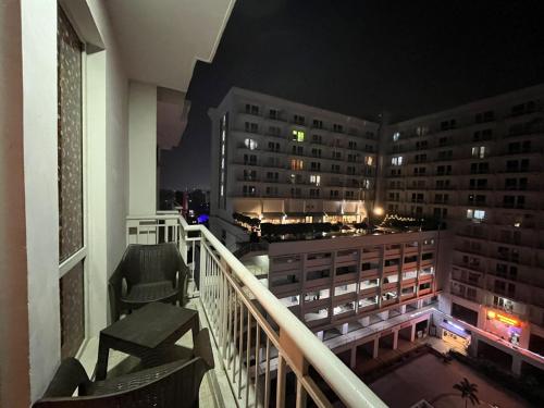 a balcony with a view of a city at night at The Nest Lucknow in Lucknow