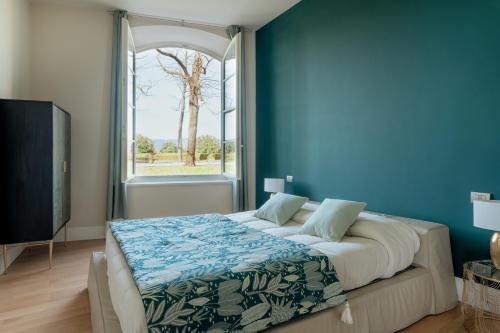 a bedroom with a large bed and a window at Casa Valentina in Lucca