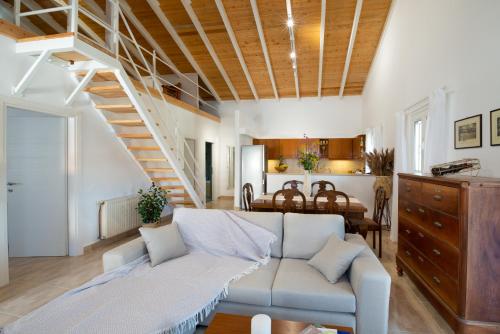 a living room with a couch and a staircase at Vive Mar Paxos in Gaios