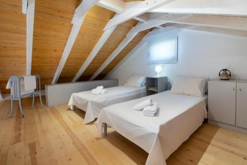Duas camas num quarto com tectos em madeira em Vive Mar Paxos em Gaios
