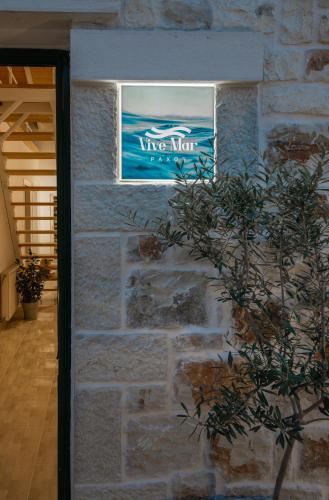 a window in a brick wall with a sign on it at Vive Mar Paxos in Gaios