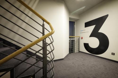 a staircase with a large number on the wall at So Stay Hotel in Gdańsk