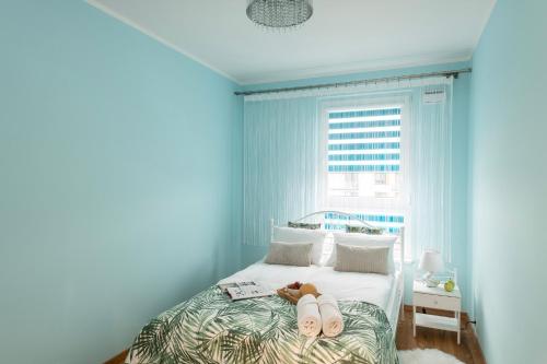 a bedroom with a bed with a teddy bear on it at ShortStayPoland Płużnicka (B115) in Warsaw