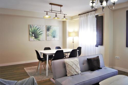 a living room with a couch and a table at Home Sweet Home junto a Mezquita / Wifi / Parking in Córdoba