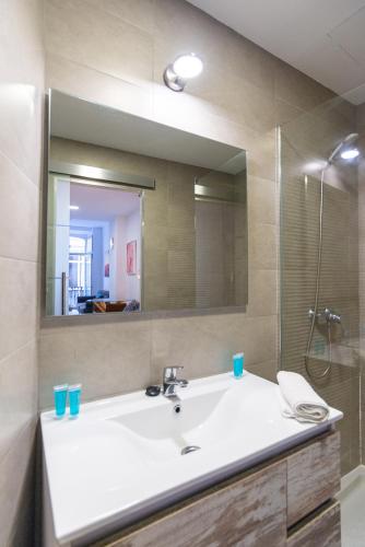 a bathroom with a sink and a mirror at Urbe10 Plaza de la Constucion Premium Loft in Málaga