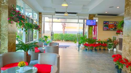 a restaurant with a table and chairs and flowers at The Bliss Loei Living in Loei