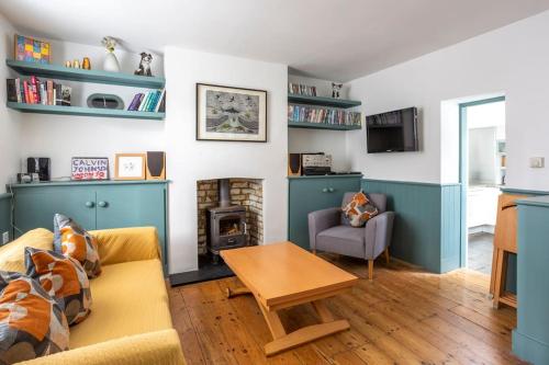 a living room with a couch and a table at Old Anchor Cottage, Broadstairs. in Broadstairs