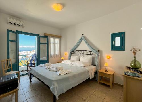 a bedroom with a bed with towels on it at Horizon Hotel in Chora Folegandros