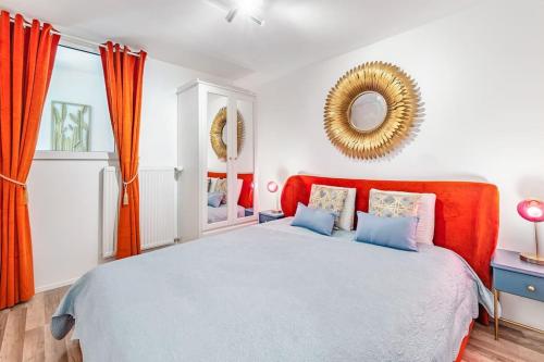 a bedroom with a large bed with an orange headboard at Urban style 3-bedroom apartment in Montreux
