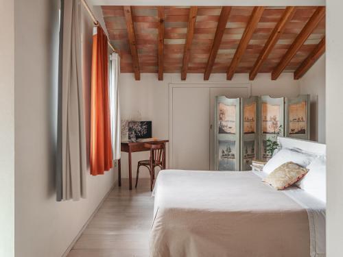 a bedroom with a white bed and a table at Masseria Scannaturco in Marina di Pisticci