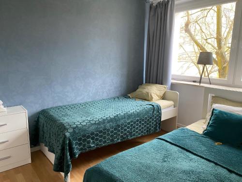 a bedroom with two beds and a window at Arco - near MERTO, PARK in Warsaw