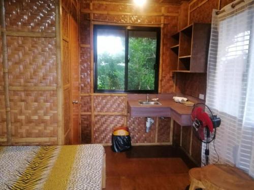 a bathroom with a sink in a wooden cabin at Almare Guest House Siquijor in San Juan