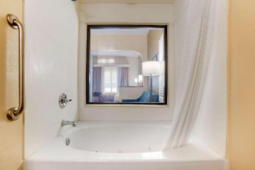 Comfort Suites Tallahassee Downtown في تالاهاسي: حمام مع حوض ومرآة