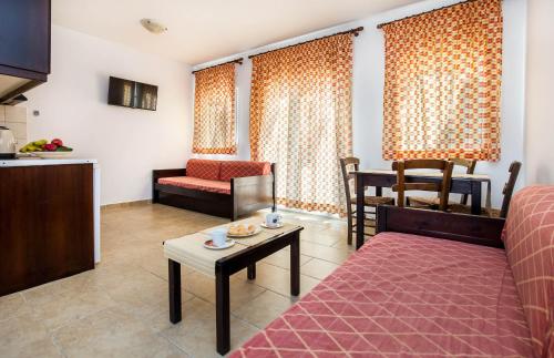 a living room with a couch and a table at Apartments Ralitsa in Limenaria