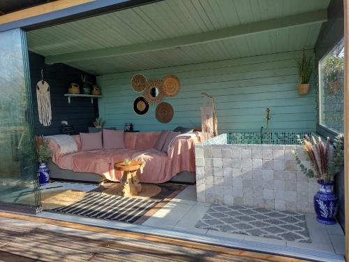 a patio with a couch and a table at Wellness Bed & Breakfast Pergamo in Voorhout
