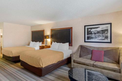 a hotel room with two beds and a couch at Quality Inn Denver Tech Center in Englewood