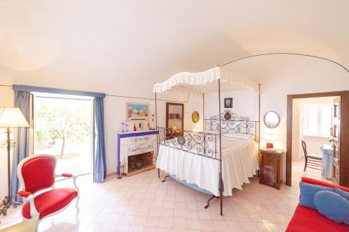 a bedroom with a canopy bed and a fireplace at Villa Le Tuie by Elite Villas in Capri