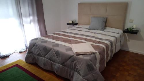 a bedroom with a large bed in a room at Apartamento Mar Azul in Vila Nova de Cerveira