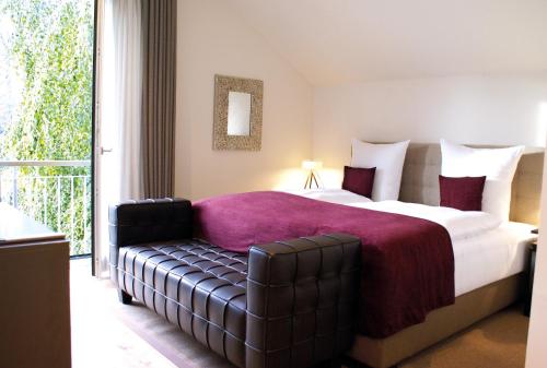 a bedroom with a large bed and a couch at Weissenhaus Private Nature Luxury Resort in Weißenhaus