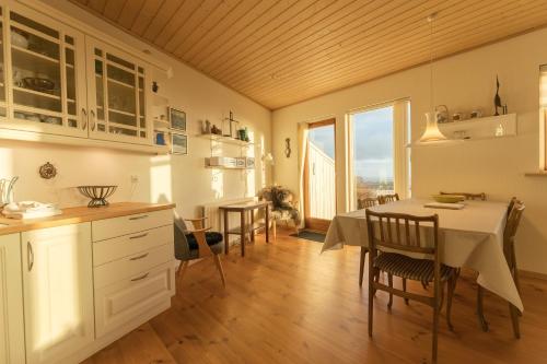 a kitchen and dining room with a table and chairs at Beautiful house in Tórshavn with a great view in Tórshavn