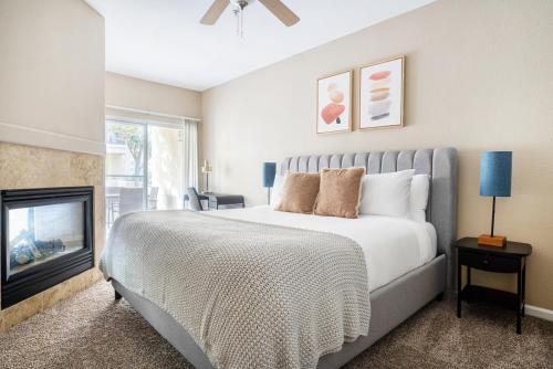 a bedroom with a large bed and a fireplace at Santa Clara 1BR w Gym Pool WD SFO-641 in Santa Clara