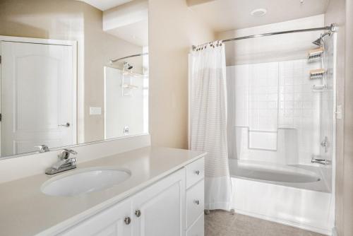 a white bathroom with a sink and a shower at Santa Clara 1BR w Gym Pool WD SFO-641 in Santa Clara