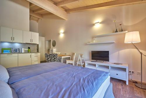 a bedroom with a large bed and a kitchen at Alb Appartements in Albstadt