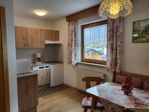 a small kitchen with a table and a window at Apartment Apart Maashof III by Interhome in Galtür