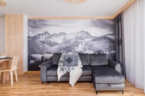 a living room with a couch and a mountain mural at Luxury Salwatoriańska Apartments Mountain View Zakopane by Renters Prestige in Zakopane