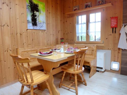 a dining room with a wooden table and chairs at Apartment Elsighornblick by Interhome in Kandergrund