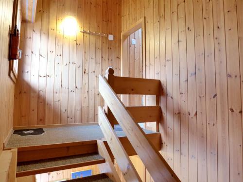 a room with a staircase in a wooden wall at Apartment Elsighornblick by Interhome in Kandergrund