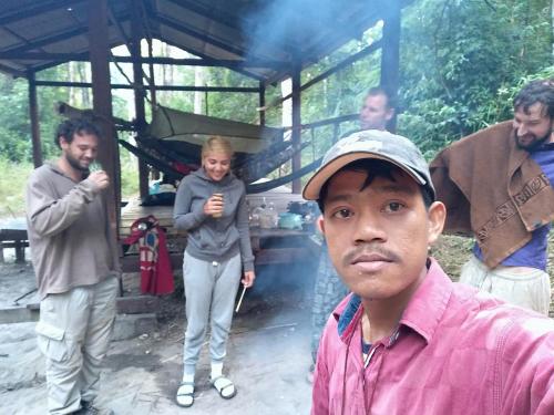 a group of people standing around a woman at Jar rai village homestay& Sona trekking tour in Banlung