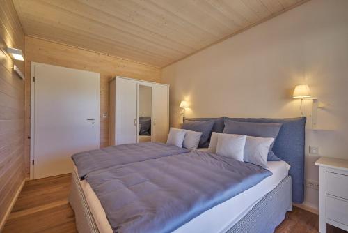 a bedroom with a large bed with blue sheets at Alb Appartements in Albstadt