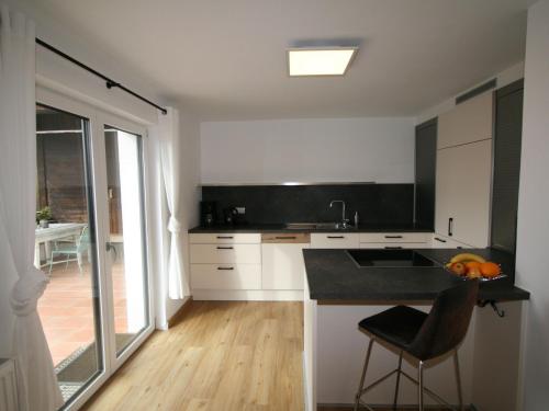 a kitchen with white cabinets and a black counter top at Apartment Lisa by Interhome in Wiesing
