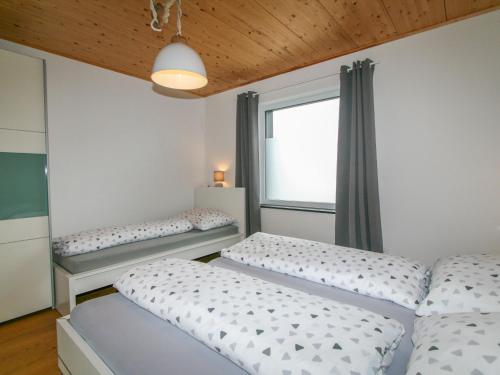 a bedroom with two beds and a window at Apartment Lisa by Interhome in Wiesing