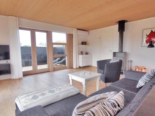 a living room with a couch and a table at Holiday Home Jasper - 175m to the inlet in Sealand by Interhome in Karrebæksminde